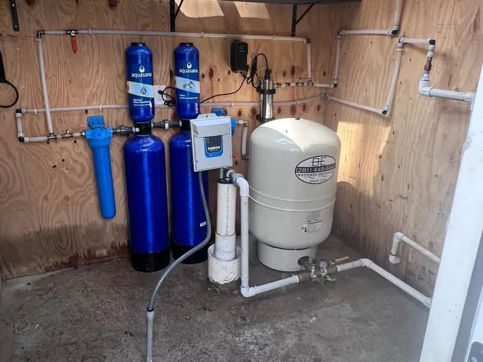 Well equipment room with filtration and pressure tank maintained by B-E Waterwell
