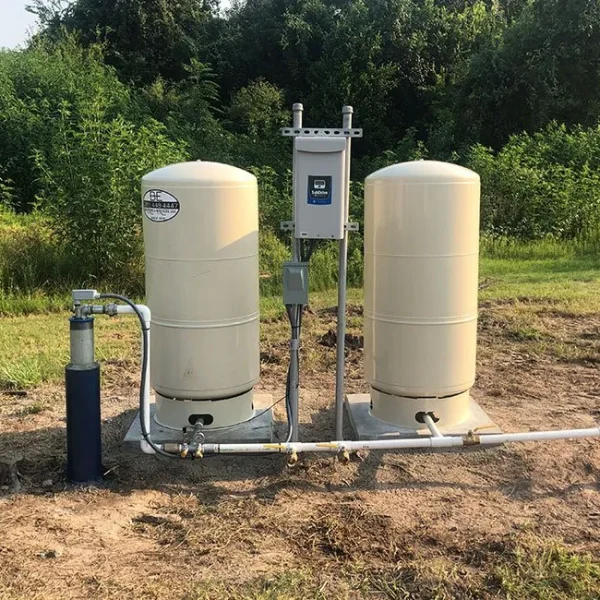 Beige outdoor pressure tank and pipe system installed by B-E Waterwell in North Houston TX